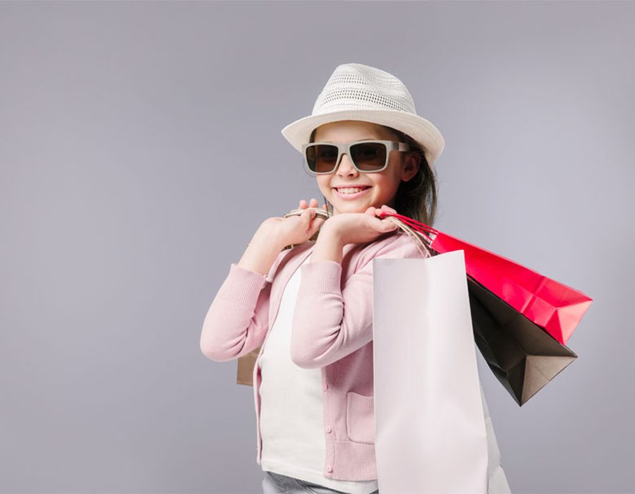A smiling shopper holding shopping bags